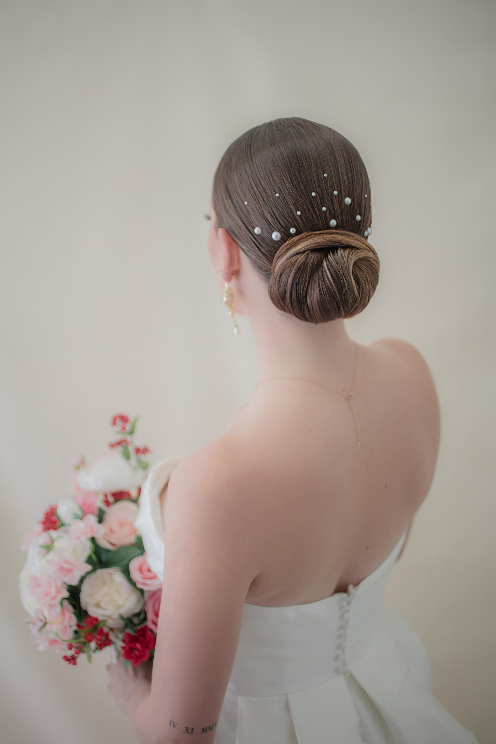 Luxury Hairstyle that features an up do with laced pearls.