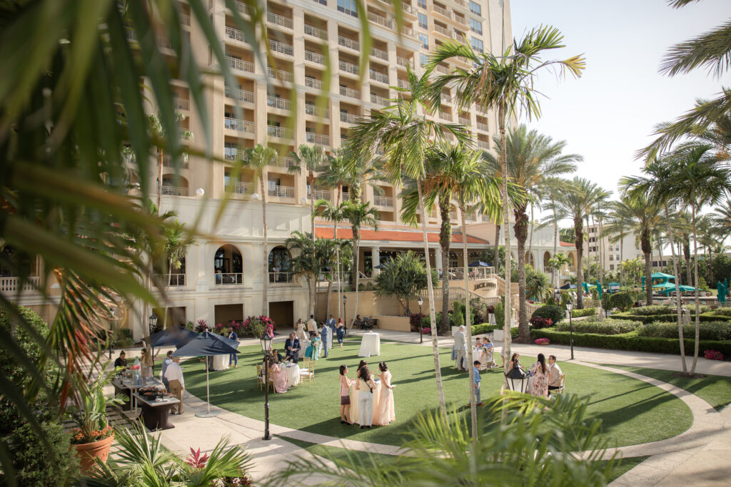 Venues in South and Central Florida are some of the most luxurious venues. This image is of a Cocktail Hour at The Ritz-Carlton. Image shows family and friends gathered for a Wedding celebration. 