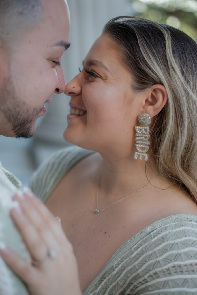 Fort Myers Engagement session: Couples having fun.  Showing off Bride earrings.