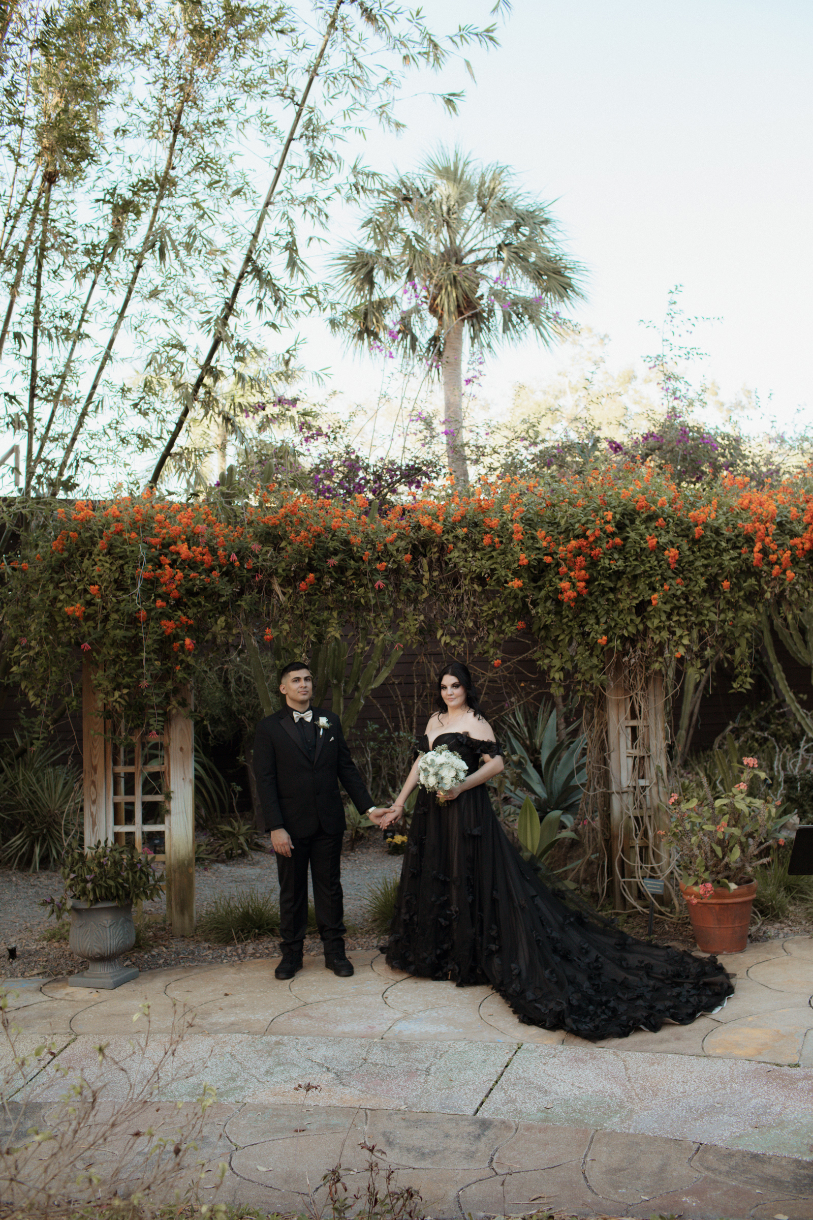 Bride and Groom portraits in front of a beautiful floral display.