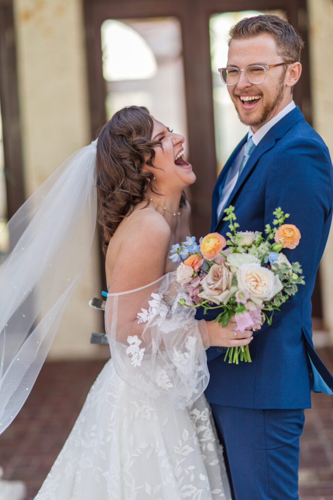 This is an image of a bride and groom laughing at Bella Cosa Wedding Venue.